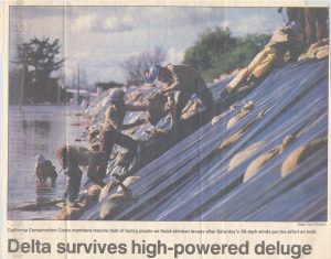 Photo of newsclipping depicting CCC Corpsmembers doing flood control work along a levee