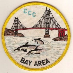 Photo of uniform patch, reads CCC Bay Area, depicts dolphins swimming under Bay Bridge