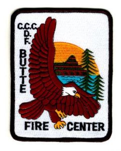 Photo of uniform patch, depicts eagle in front of forest and lake, reads CCC CDF Butte Fire Center