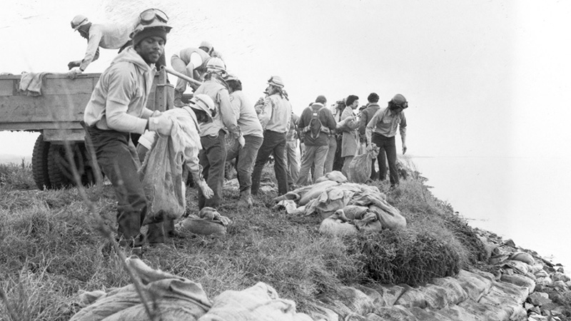 Vintage photograph of corpsmembers working with sandbags.