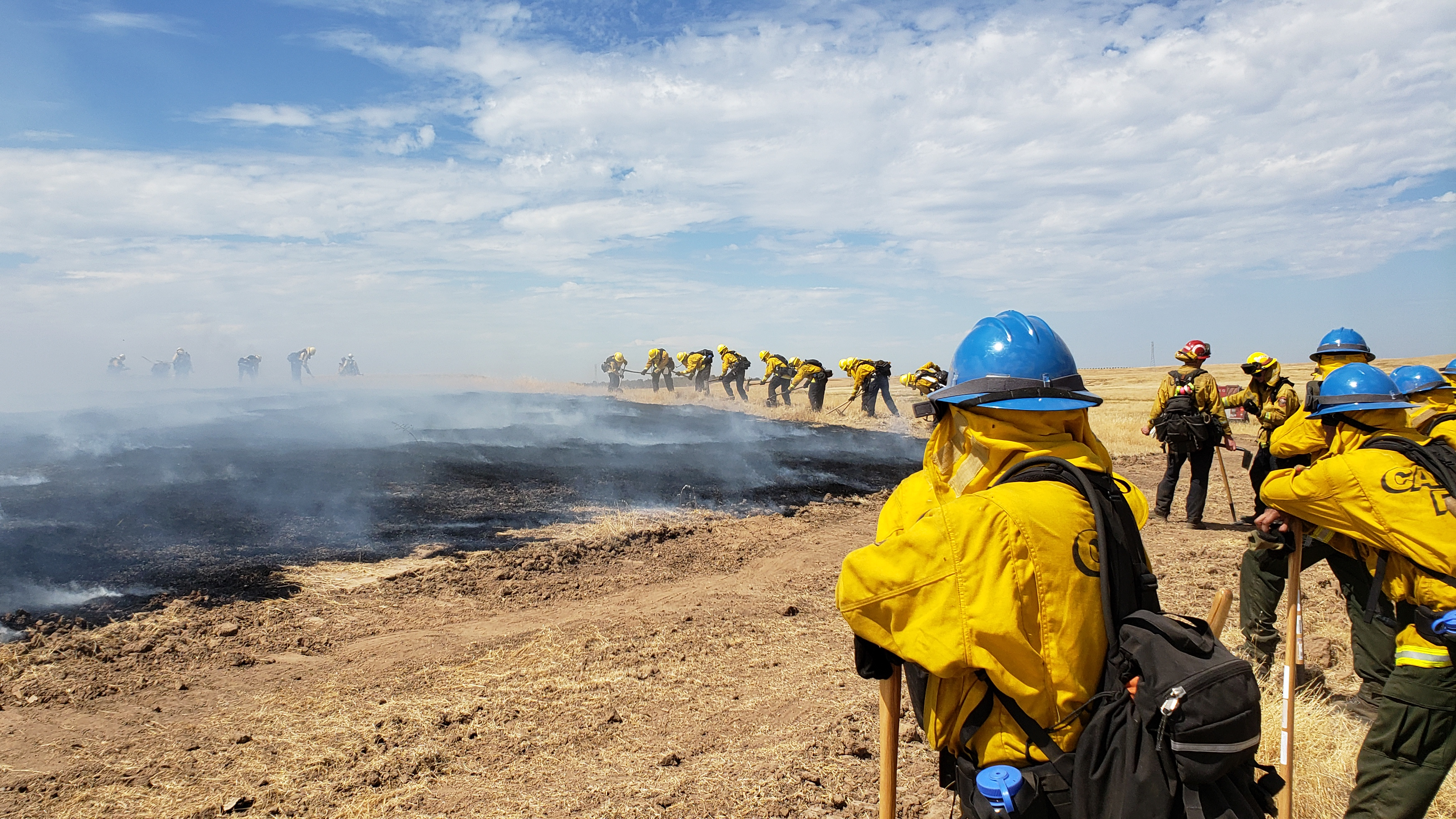 Corpsmembers practicing deploying their emergency shelters during fire training.