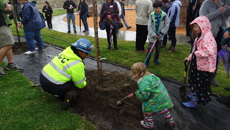 Corpsmember at a volunteer event with community members.