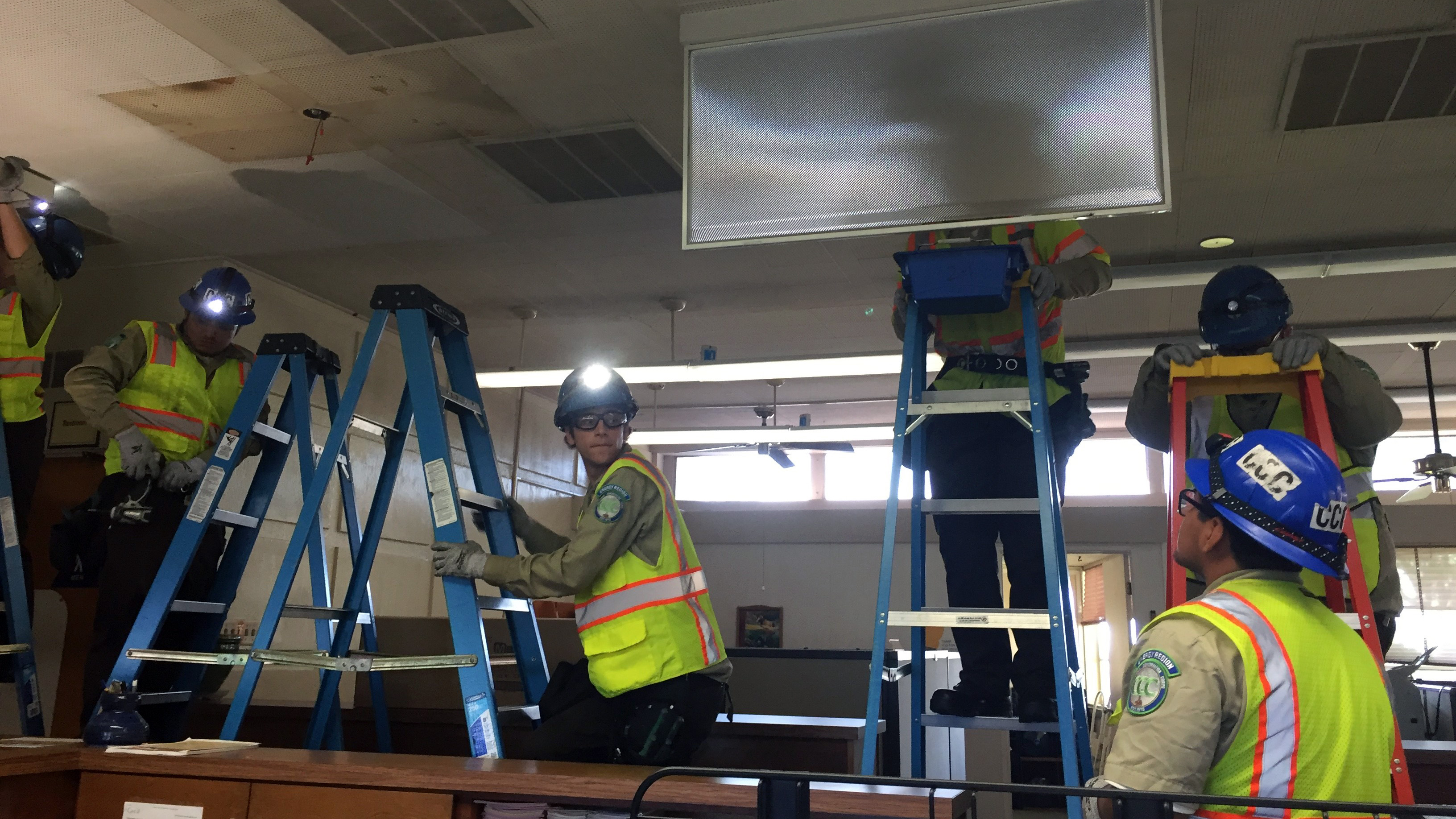 Norwalk Energy Hub crew wearing head lamps to light up their work area.