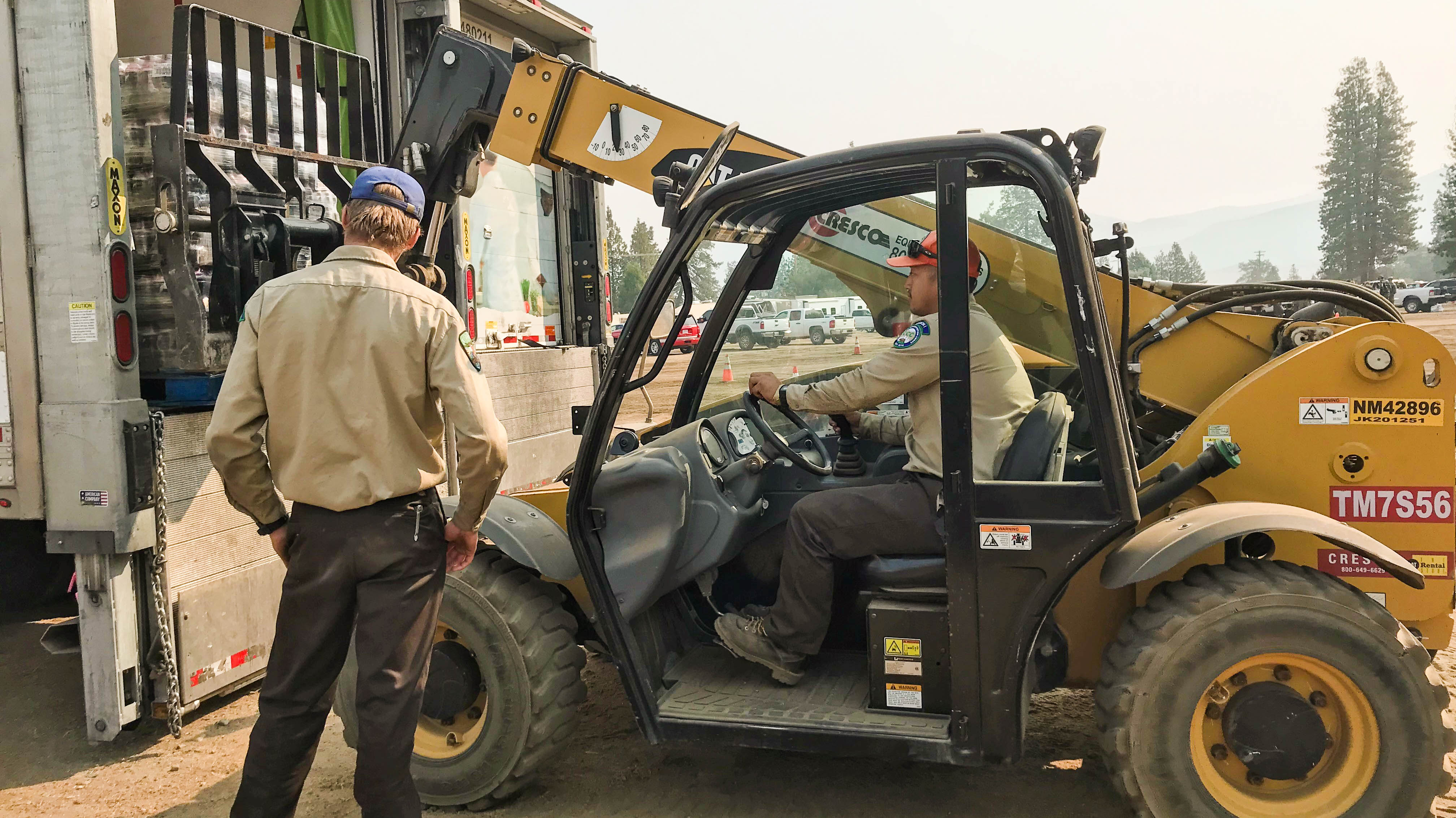 man standing near forklift moving supplies