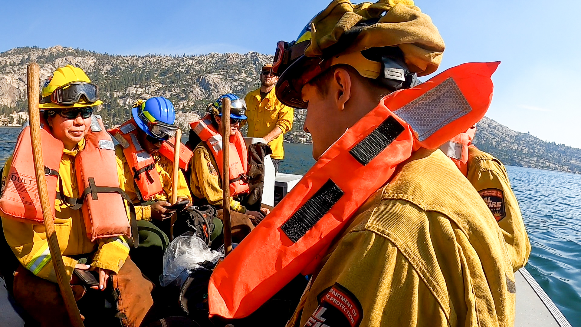 Close up of a corpsmember wearing a life jacket on a boat.