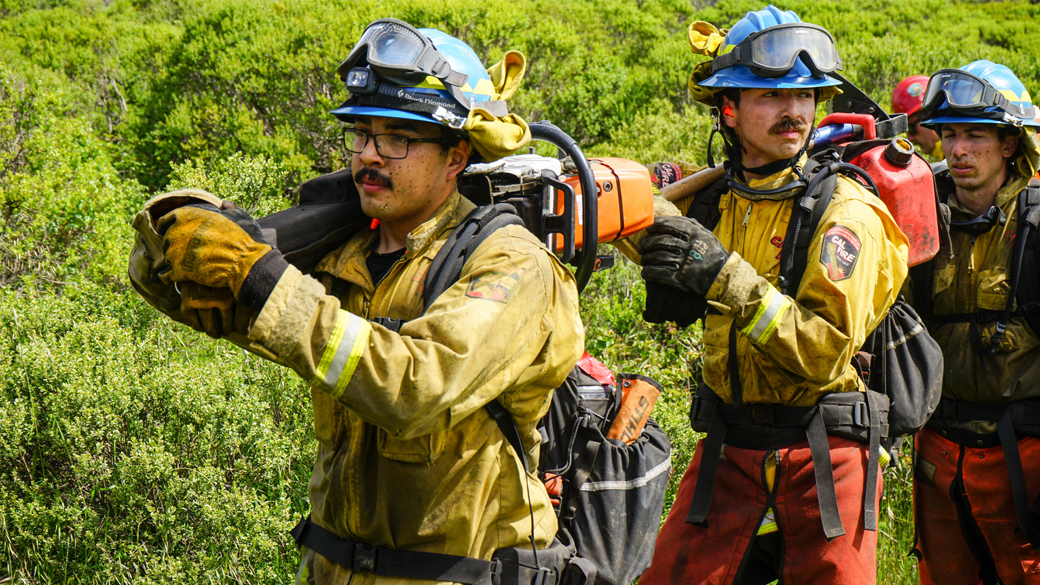 firefighters with debris on their faces wait in hook line for the next phase of their readiness drill near pescadero