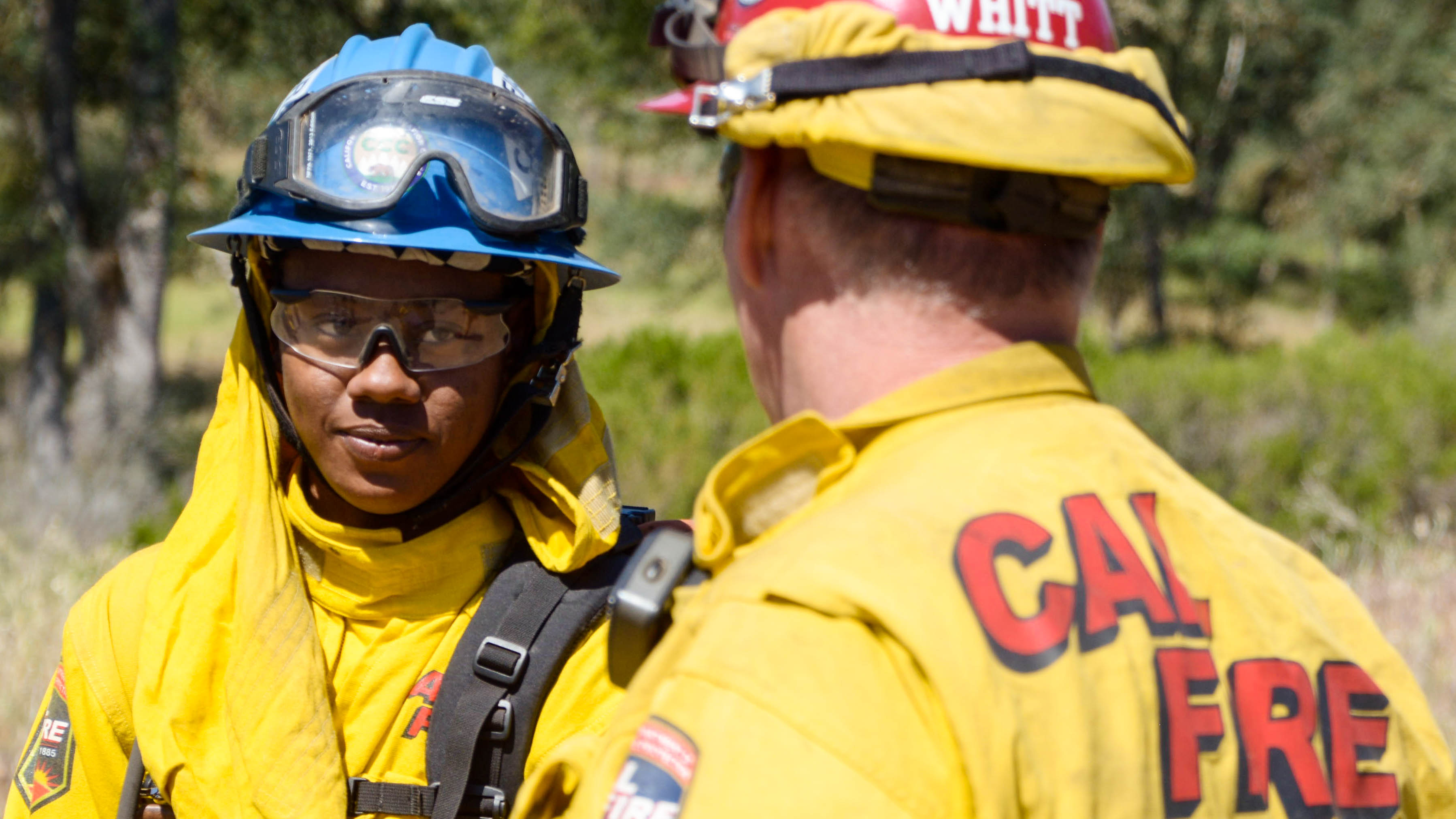 Two Delta Center Corpsmembers work to remove a rock.