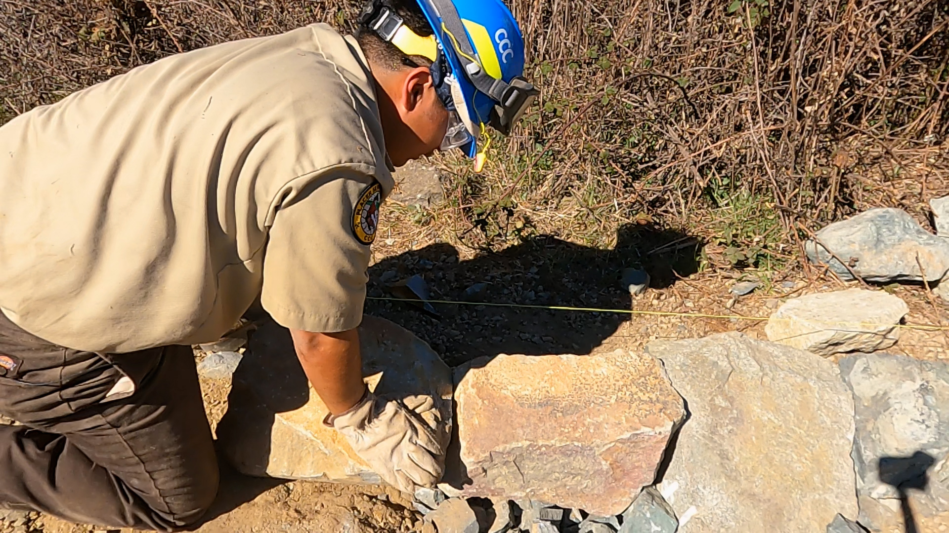 corpsmember examining rocks
