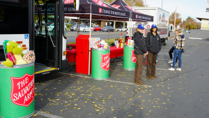 two corpsmembers standing outside stuff the bus in chico