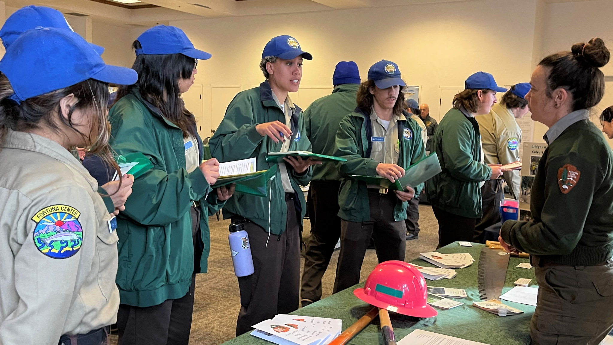 Corpsmembers speak to staff from the National Park Service while attending a career fair. 