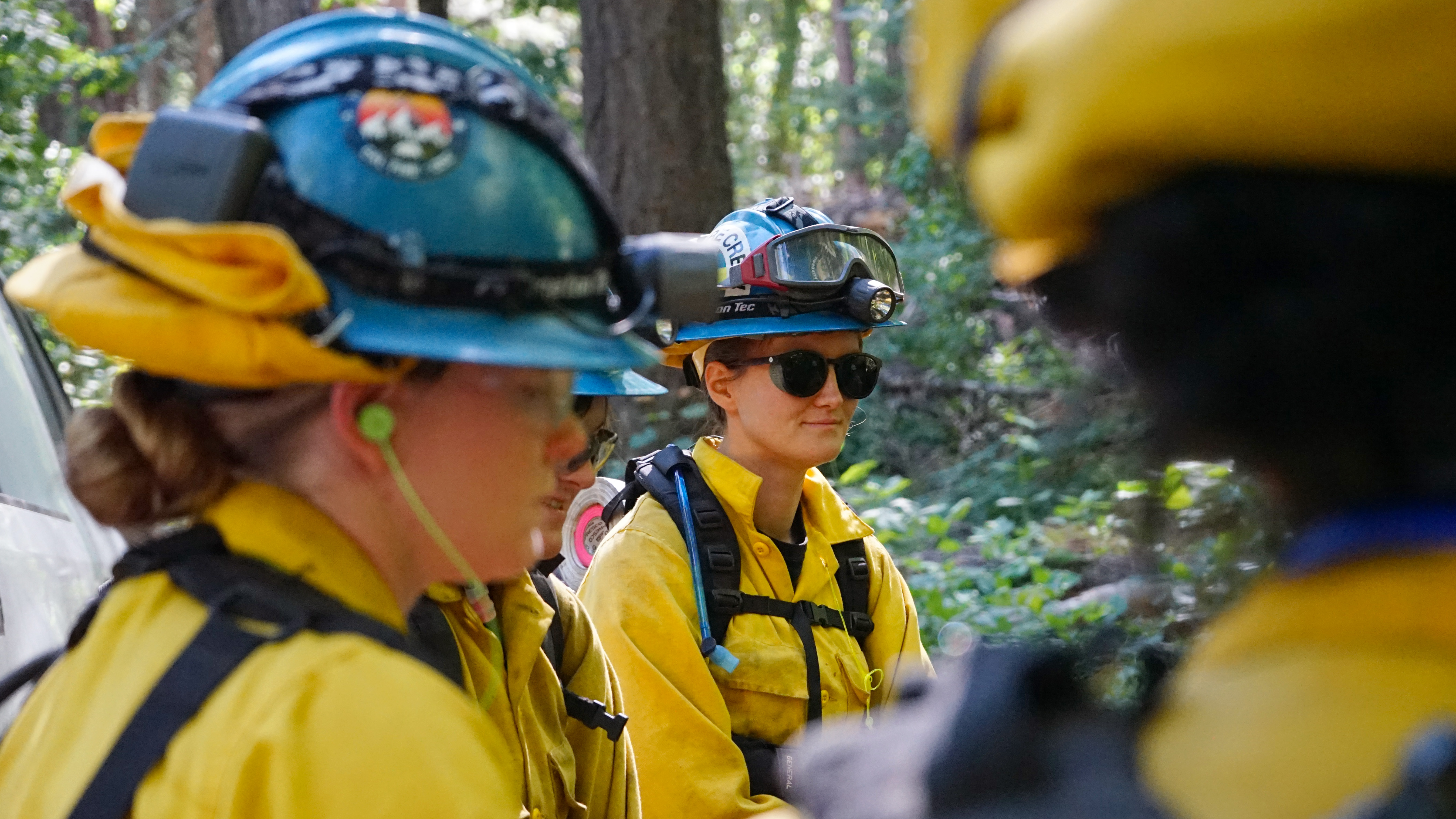 women in fire equipment listening intently