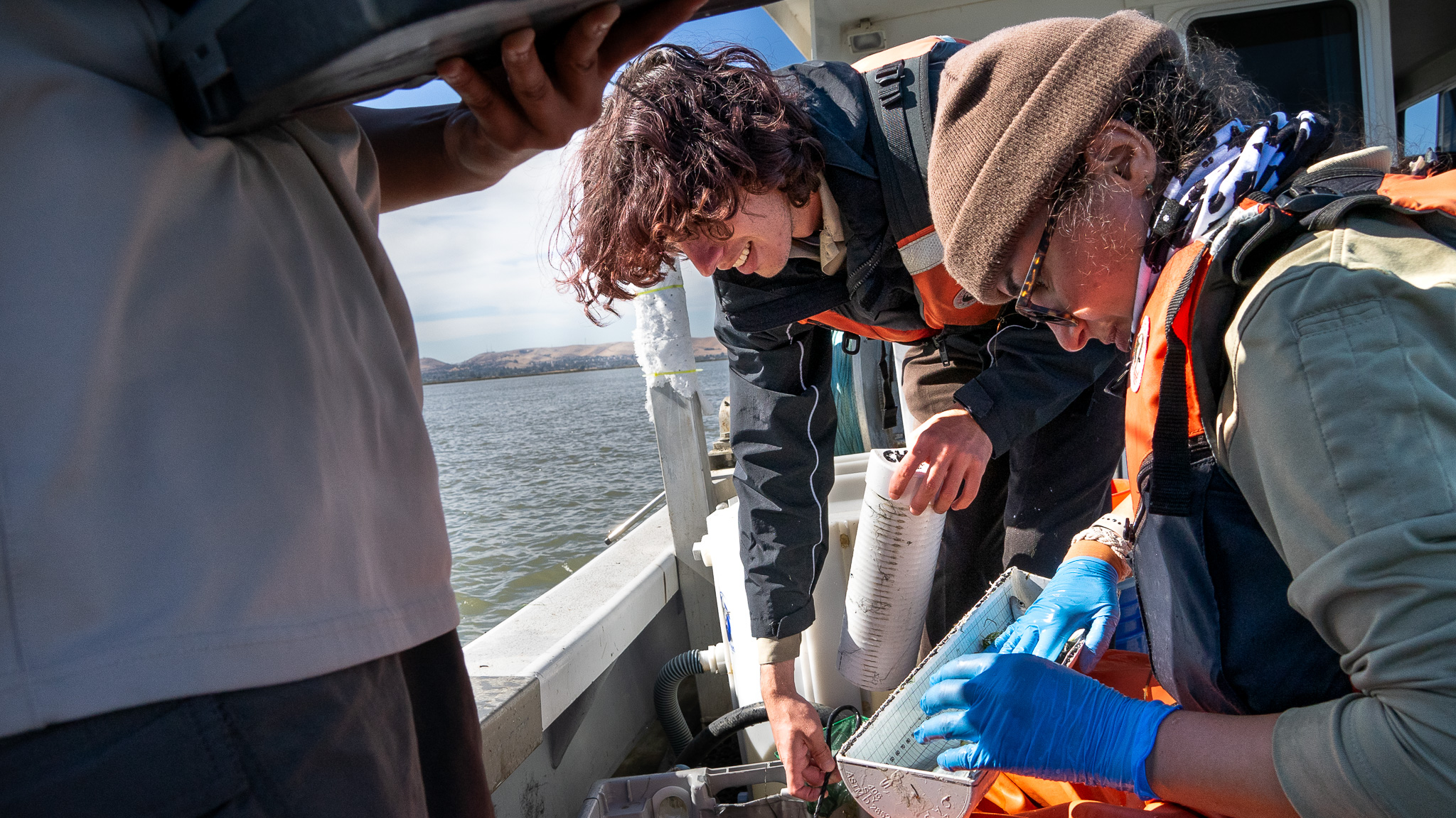 Josafat and the U.S. Fish & Wildlife Service team measure the lengths of the fish they caught and log the data. 
