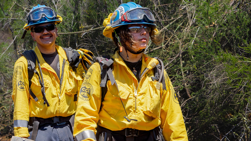 firefighter standing ready in uniform smiling