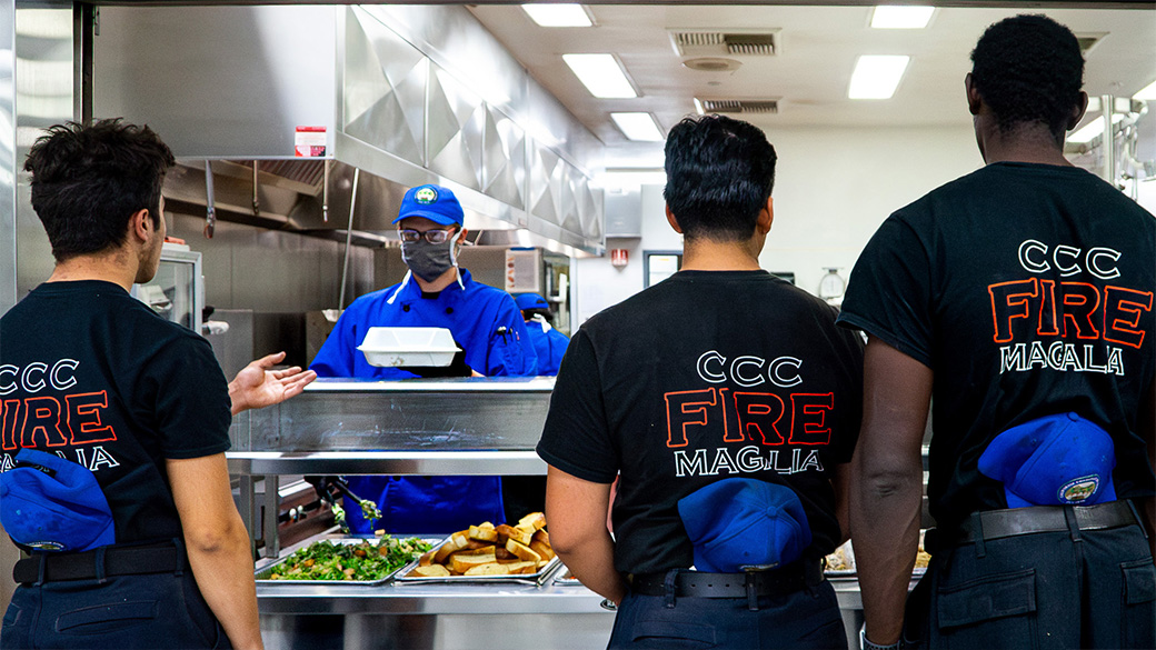 corpsmembers waiting to be served dinner in line