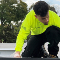 photo of man working on roof