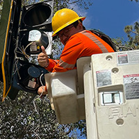 photo of man working on traffic light
