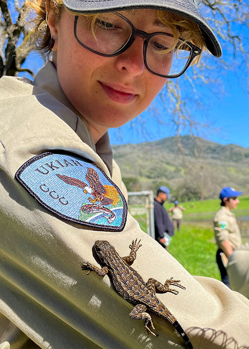 SideImage_Mendocino_500x700 Corpsmember with a small lizard on their arm.