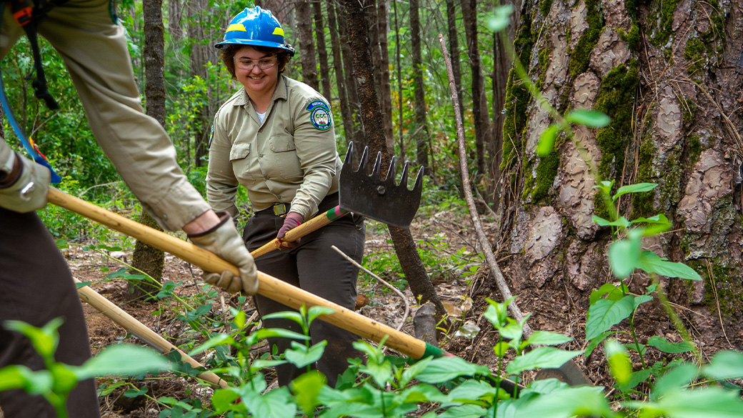 Corpsmember using a McLeod during prescribed burn prep.