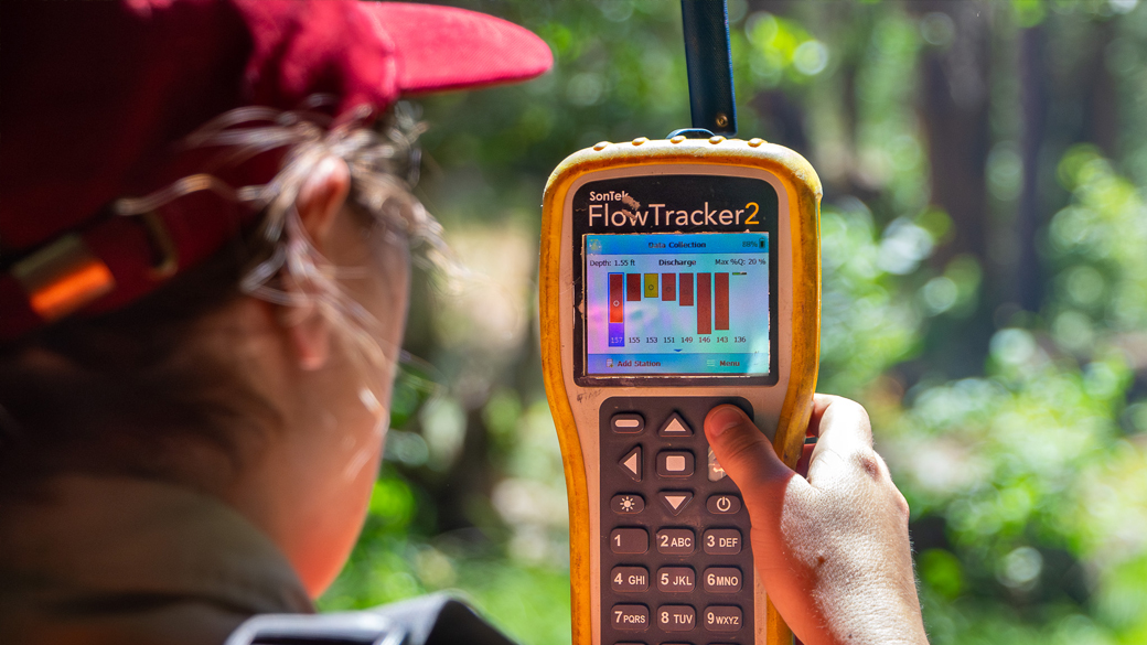 Interns_Chico_DWRFlowTracker_072325_1040x585 over the shoulder photo of female using a flow tracker device