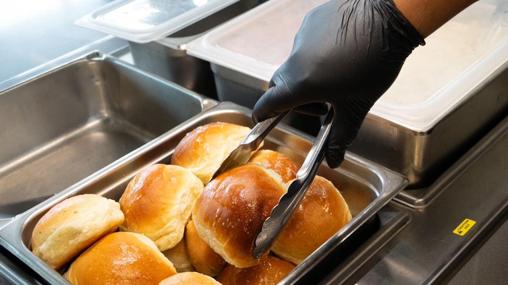 tongs grabbing a buttered