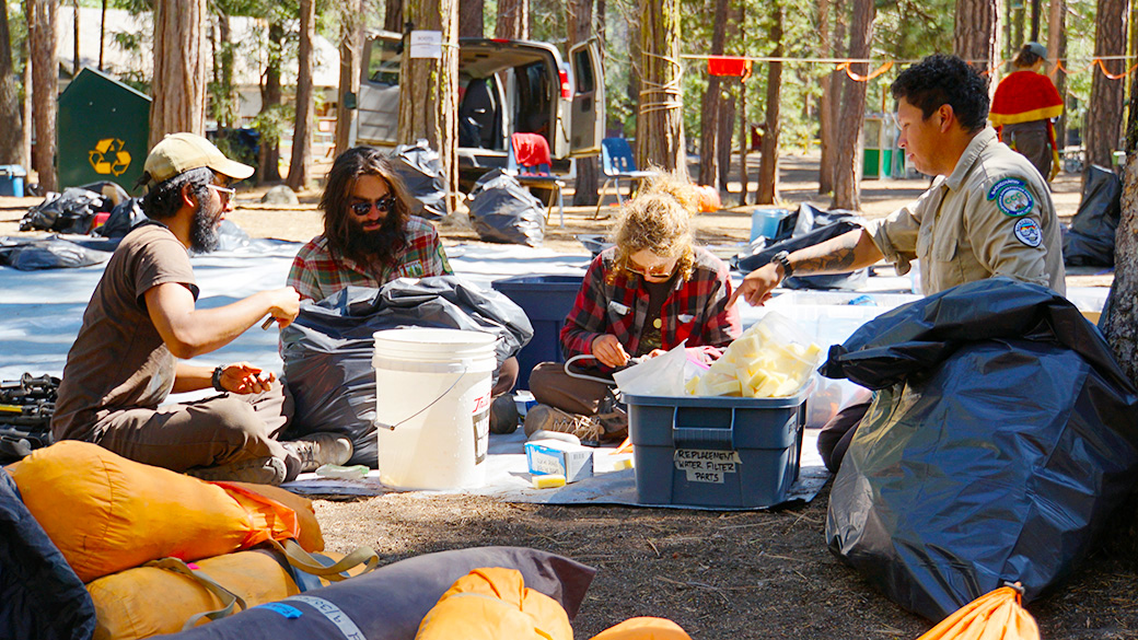 corpsmembers sorting through items on the ground