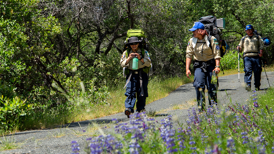 corpsmembers hiking with backpacks