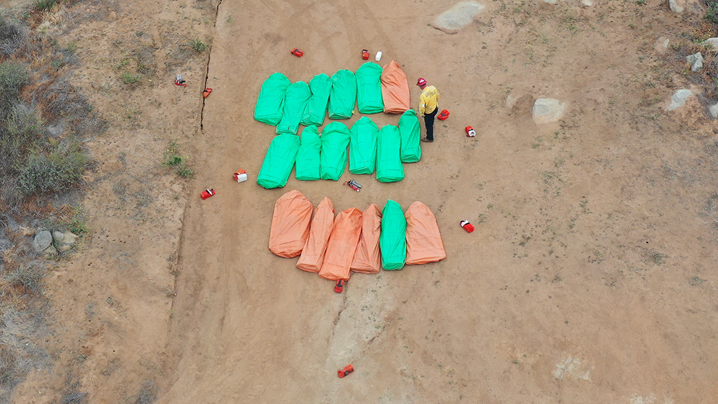 aerial view of corpsmembers in practice shelters on the ground during readiness drill