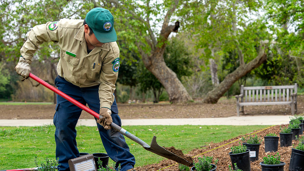 male corpsmember using shovel to remove dirt from the ground