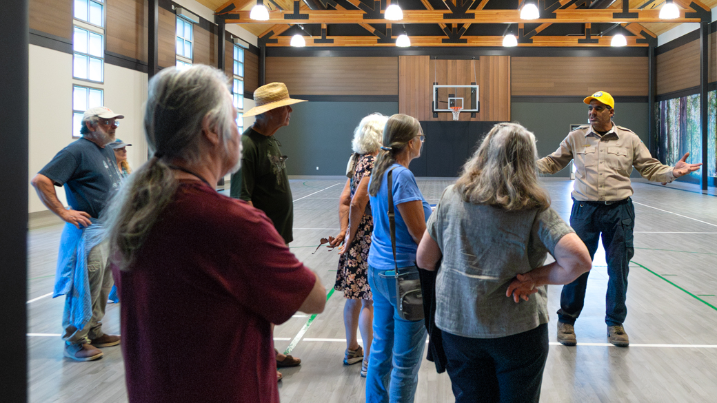 A tour group views the gym at the CCC Mendocino Center
