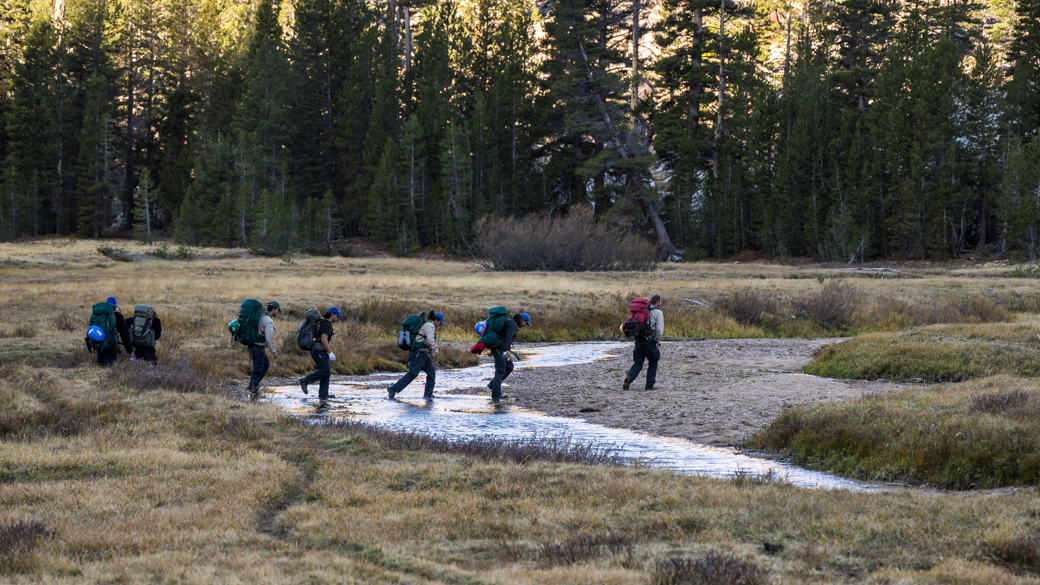 CCC Corpsmembers start their hike out after helping install a new weather station.