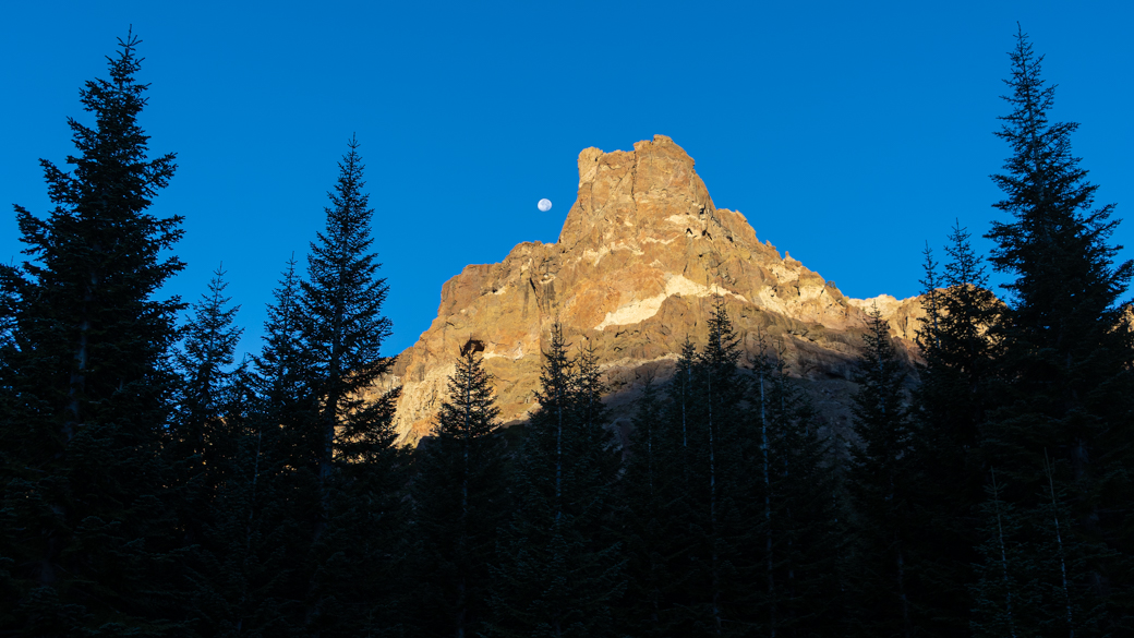 The moon rises above the mountains in the Stanislaus National Forest.