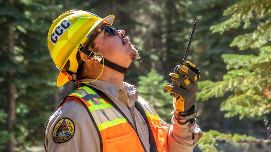 C1 Gio Chacon looks up while holding a radio