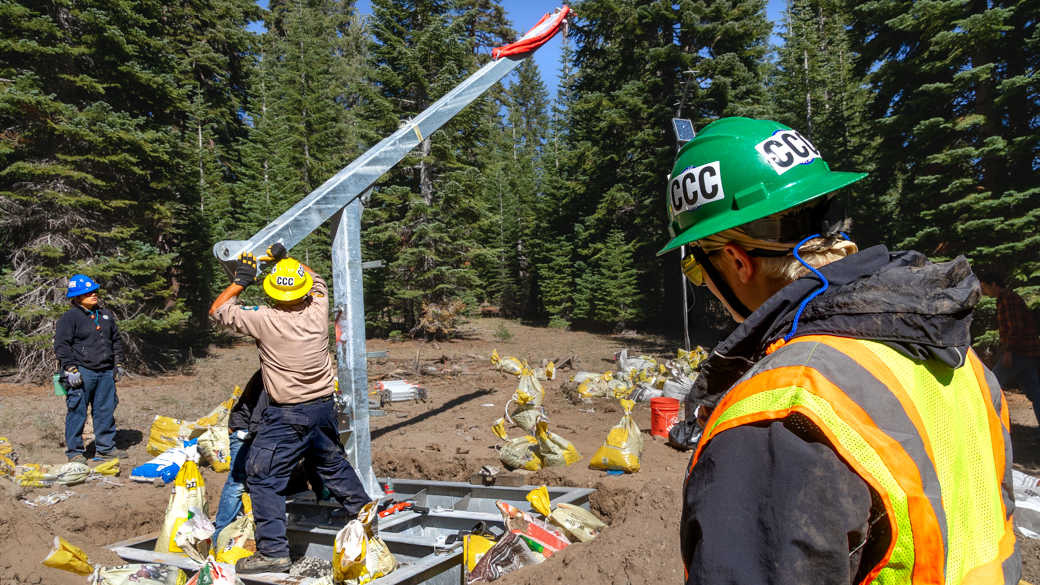 C1 Gio Chacon helps adjust the Hinge Fold Tilt-Pole while on a DWR weather station installation project.