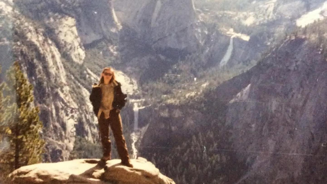 Tami Skaggs pses at a scenic overlook in Yosemite.