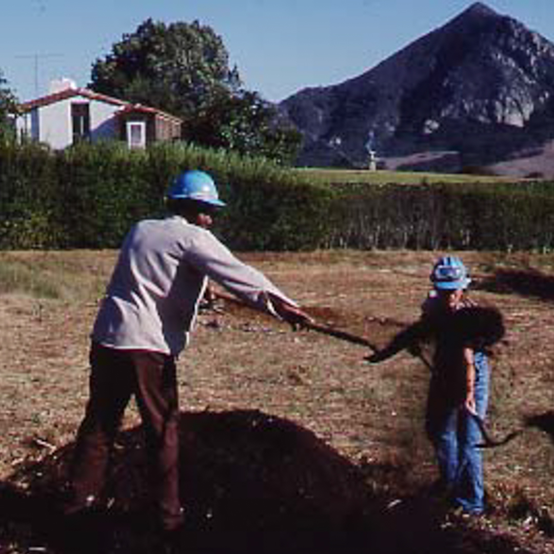 Corpsmembers dig a hole with a shovel in SLO.