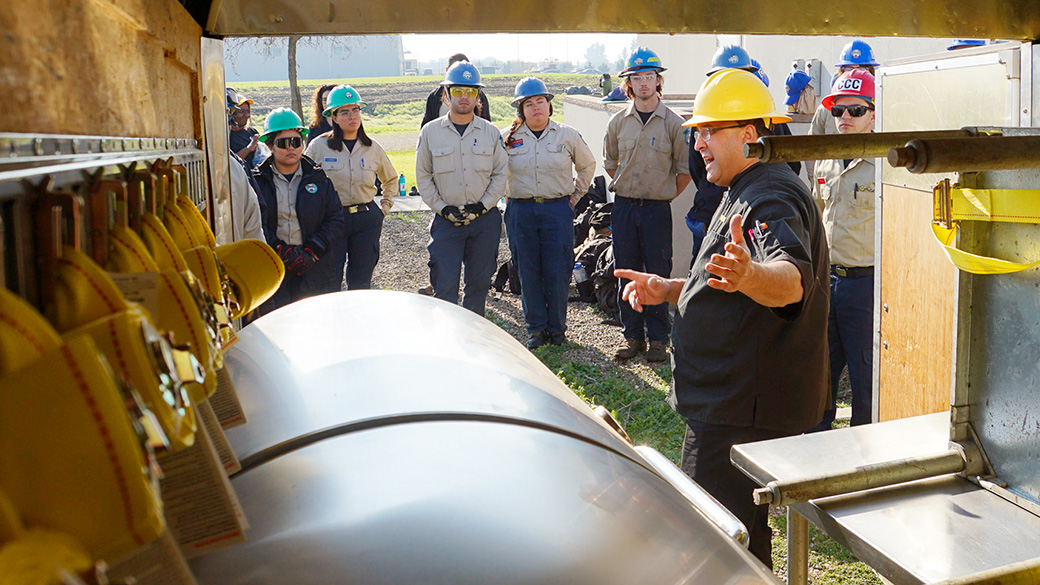 supervising cook stephen beck talks to corpsmembers about unloading a support trailer