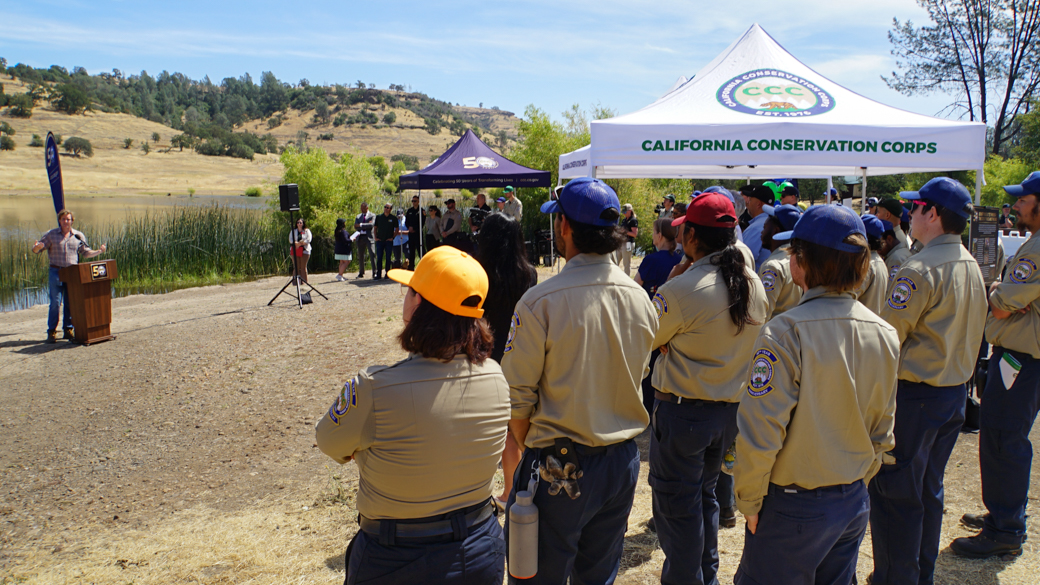 CCC Corpsmembers listen attentively to speakers at the bus stop in Chico.