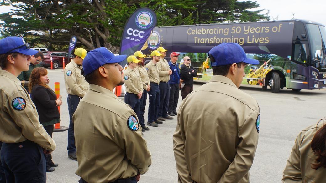 CCC Corpsmembers listen attentively to speakers at the bus stop in Monterey Bay. 